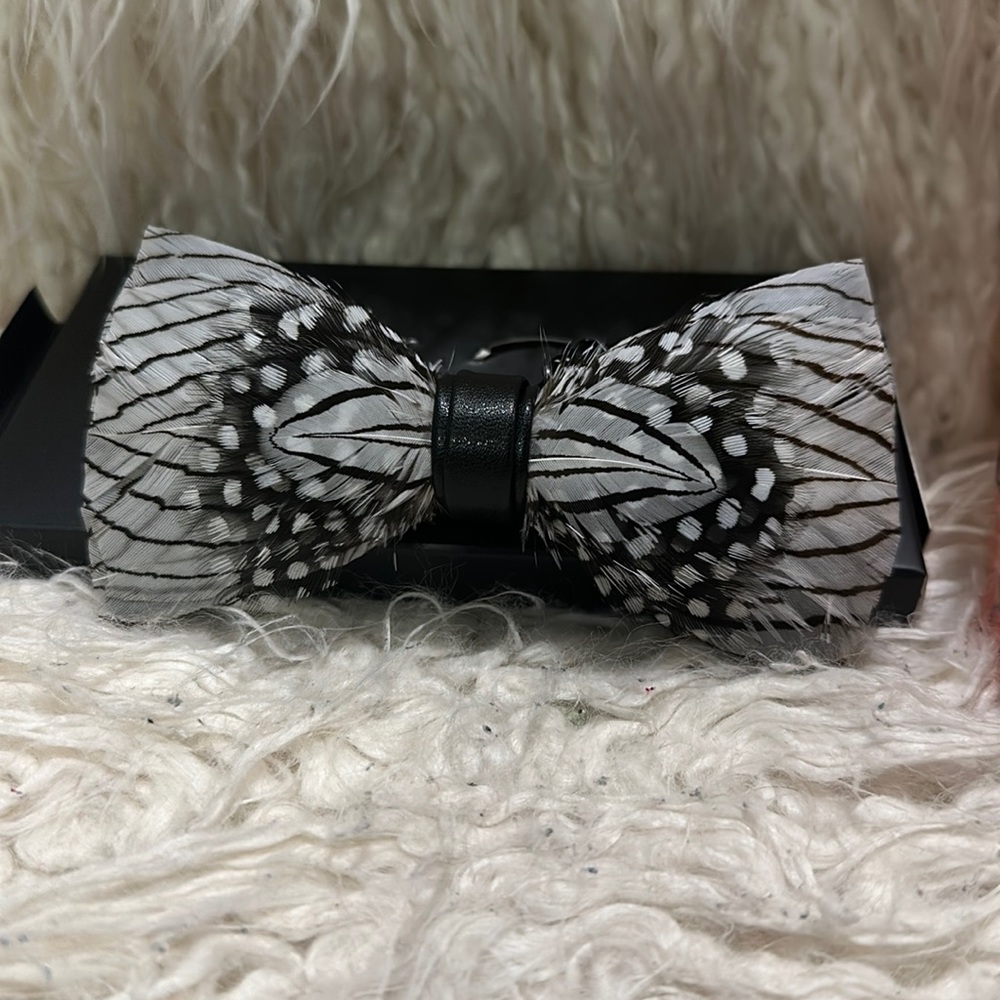 Brand new feather bow tie - black and white.  New in box.   Really unusual.